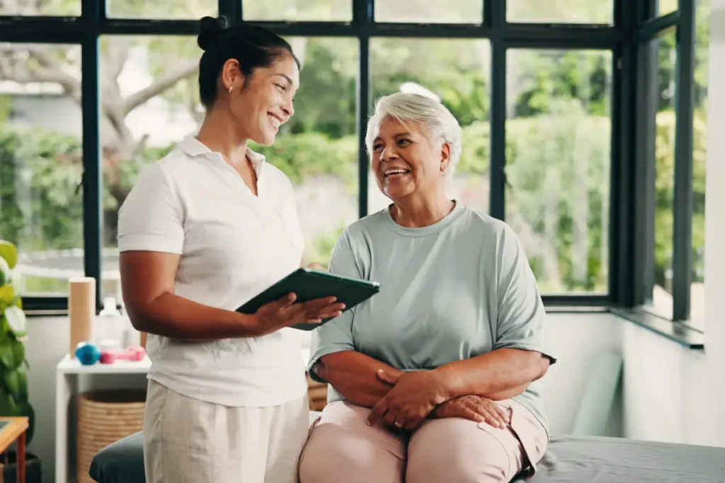 Healthcare provider consulting with patient using tablet in bright clinical room